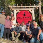 Group photo around Eagle Wings Lodge entrance